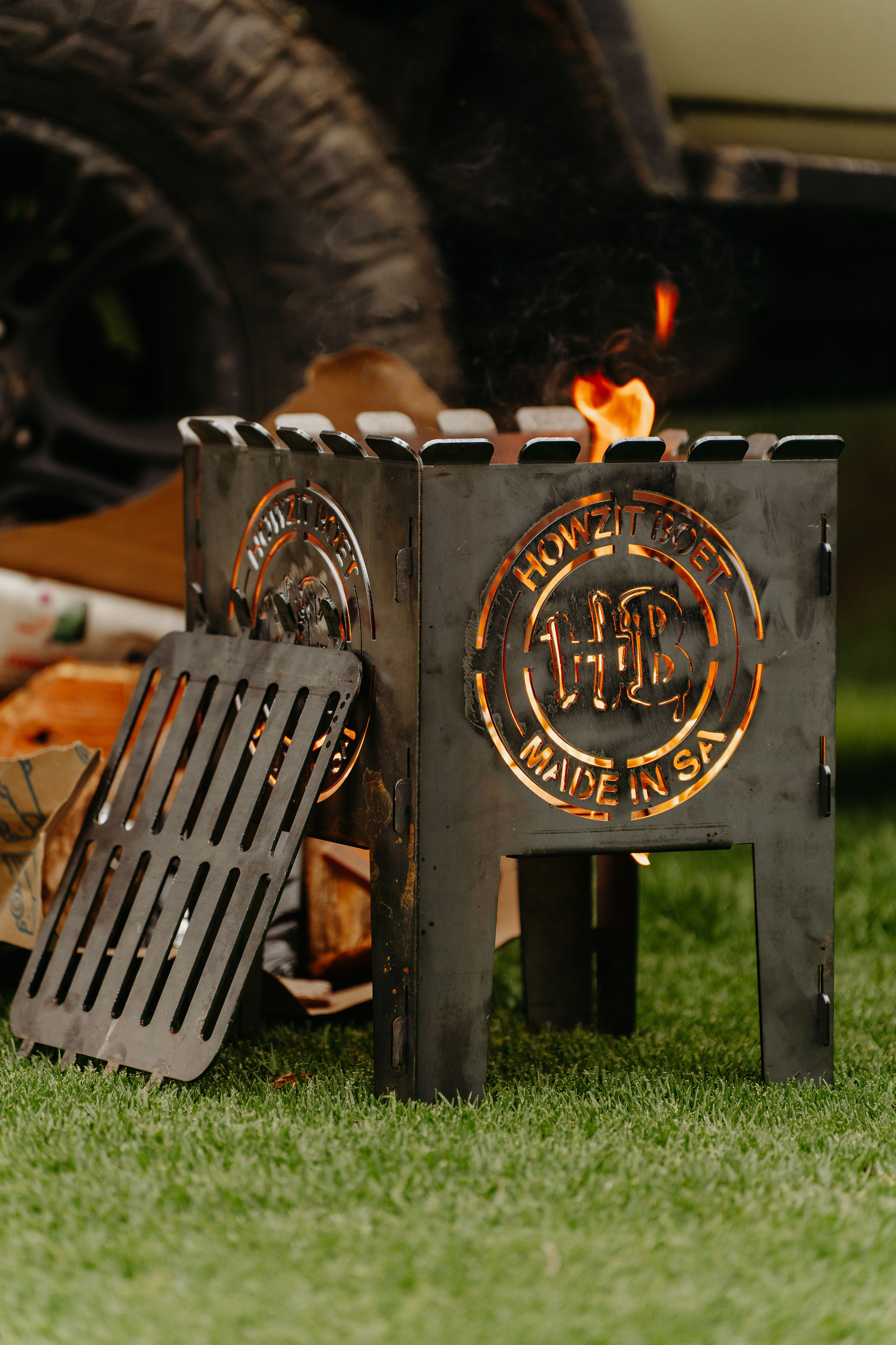 Friends gathered around the braai fire